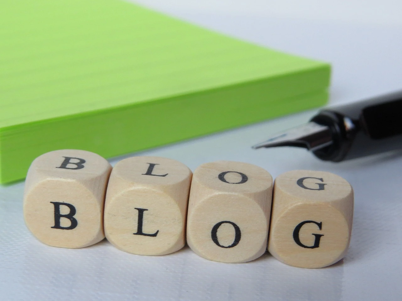 The word "BLOG" spelled out on wooden blocks, suggesting the act of writing or creating online content